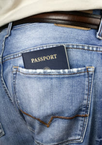 Passport in the back pocket of a pair of men's jeans